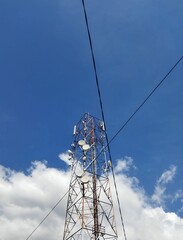 Telecommunication tower with blue sky background.