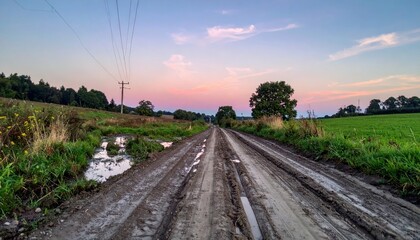 Peaceful Rural Road With Muddy Path Under Colorful Sunset Sky