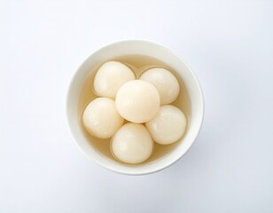 Sweet dumplings in syrup in a white bowl, viewed from above