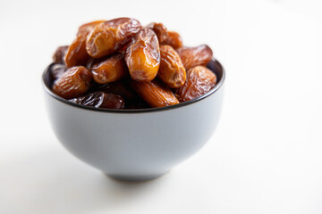 Delicious dates in a bowl on white. High quality photo