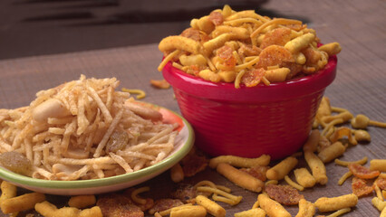 Indian Snacks, Traditional Indian deep fried salty dish called chivda or mixture or farsan made of gram flour and mixed with dry fruits and roasted nuts with salt, pepper, pulses, spice and green peas