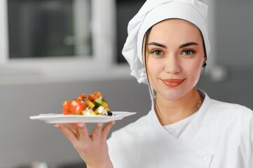 Female chef in kitchen. Cooking concept