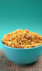 Indian Snacks, Traditional Indian deep fried salty dish called chivda or mixture or farsan made of gram flour and mixed with dry fruits and roasted nuts with salt, pepper, pulses, spice and green peas
