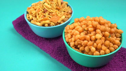 Indian Snacks, Traditional Indian deep fried salty dish called chivda or mixture or farsan made of gram flour and mixed with dry fruits and roasted nuts with salt, pepper, pulses, spice and green peas