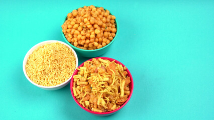 Indian Snacks, Traditional Indian deep fried salty dish called chivda or mixture or farsan made of gram flour and mixed with dry fruits and roasted nuts with salt, pepper, pulses, spice and green peas