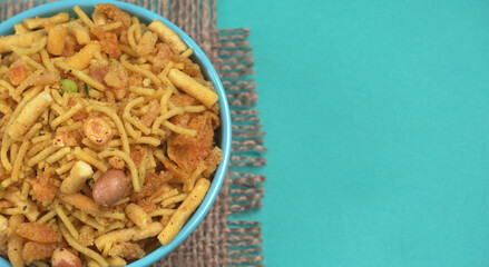 Indian Snacks, Traditional Indian deep fried salty dish called chivda or mixture or farsan made of gram flour and mixed with dry fruits and roasted nuts with salt, pepper, pulses, spice and green peas