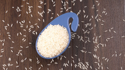 Healthy food. Wooden bowl with parboiled rice on white background. Top view, copy space, high...