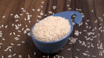 Healthy food. Wooden bowl with parboiled rice on white background. Top view, copy space, high resolution product.

