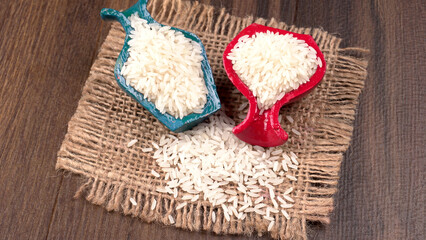 Healthy food. Wooden bowl with parboiled rice on white background. Top view, copy space, high resolution product.
