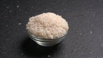 Healthy food. Wooden bowl with parboiled rice on white background. Top view, copy space, high...