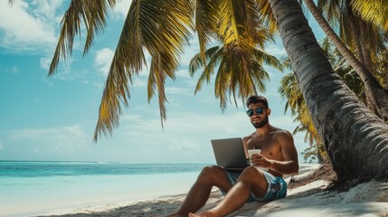 handsome man on vacation on beach with laptop