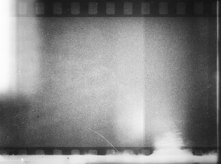 80's negative photo film with grain scratches dust, film grain  photo overlay background, light leaks texture effect. Grainy negative photo film textures
