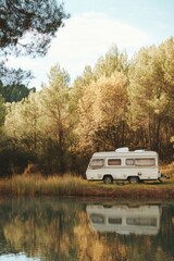 Campervan parked lakeside in serene forest setting, reflective water, peaceful nature getaway, eye level view, travel lifestyle