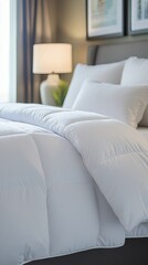 Close up of white down comforter on bed in bedroom interior with pillows and headboard for cozy comfort