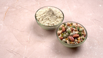 Uncooked pulses,grains and seeds in colourful bowl over wooden background. selective focus