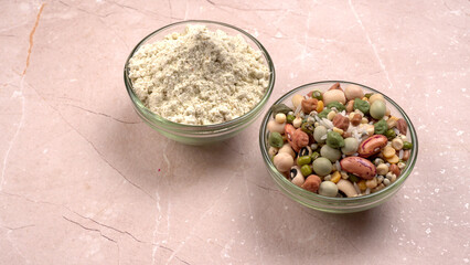 Uncooked pulses,grains and seeds in colourful bowl over wooden background. selective focus