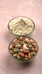 Uncooked pulses,grains and seeds in colourful bowl over wooden background. selective focus
