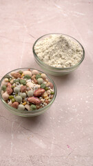 Uncooked pulses,grains and seeds in colourful bowl over wooden background. selective focus