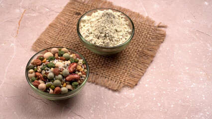 Uncooked pulses,grains and seeds in colourful bowl over wooden background. selective focus