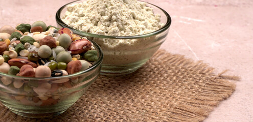 Uncooked pulses,grains and seeds in colourful bowl over wooden background. selective focus