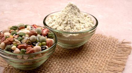 Uncooked pulses,grains and seeds in colourful bowl over wooden background. selective focus