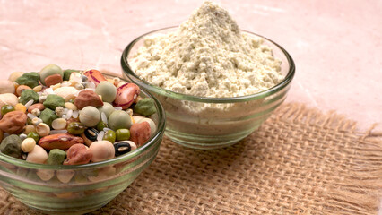 Uncooked pulses,grains and seeds in colourful bowl over wooden background. selective focus