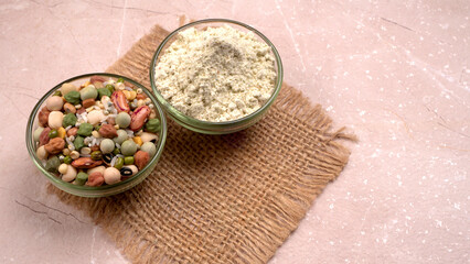 Uncooked pulses,grains and seeds in colourful bowl over wooden background. selective focus