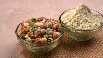 Uncooked pulses,grains and seeds in colourful bowl over wooden background. selective focus