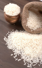 Healthy food. Wooden bowl with parboiled rice on white background. Top view, copy space, high resolution product.
