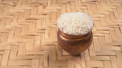 Healthy food. Wooden bowl with parboiled rice on white background. Top view, copy space, high...