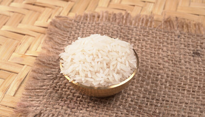 Healthy food. Wooden bowl with parboiled rice on white background. Top view, copy space, high resolution product.
