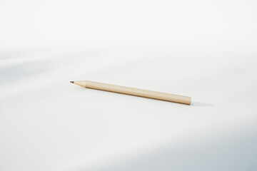 Wooden pencil lying on white background with copy space