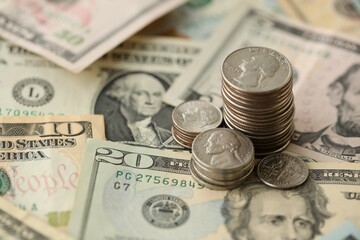 American US dollars money bills with coins and constitution close up on american flag
