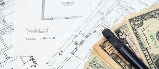 Big amount of US dollars money bills with pen and planning blueprints of residential building project close up. Investment and construction project concept