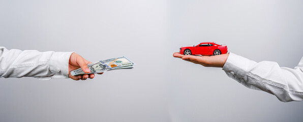 A man holds a car on his hand