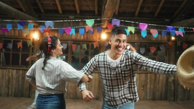 Exuberant Dancers Twirling in Sync at Brazilian Folk Festival. Couples in Plaid Outfits Reveling in Traditional Junina Dance Celebrations