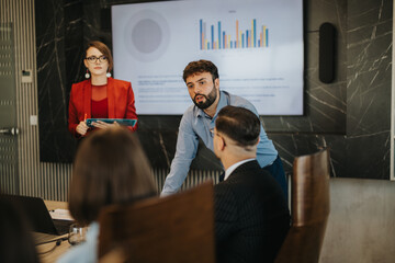 A multicultural group of business people engaged in a conference room meeting, discussing data...