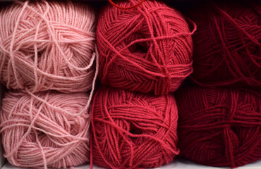 Shop shelves with multicolored skeins of yarn for knitting. Yarn for knitting for needlework. Bright multicolored threads.