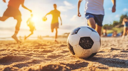 Beach soccer game with friends and family enjoying summer vacation on the sand at sunset activity fun