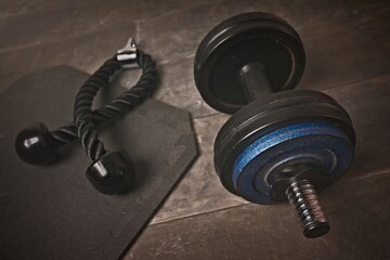 High angle view of dumbbell on floor next to a Bicep,
Rope,.