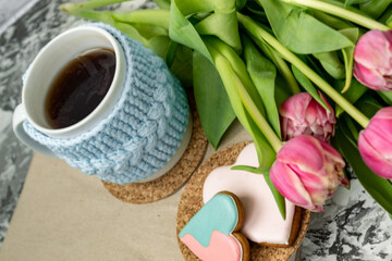Pink tulips, an open book and a mug of freshly brewed coffee or tea. Spring set. Flatley layout.