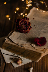 Bouquets of dried flowers with old vintage book on wooden nostalgic vintage background