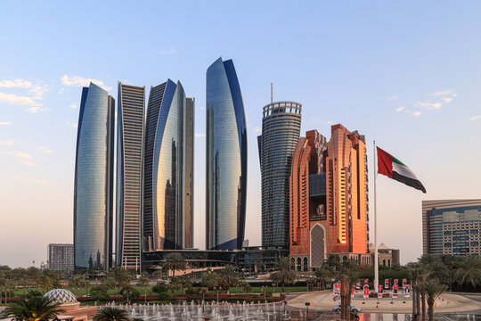 Abu Dhabi, UAE - February 27. 2023: Etihad Towers with UAE flag. Etihad Towers are a group of five buildings for offices, apartments and the hotel Grand Hyatt