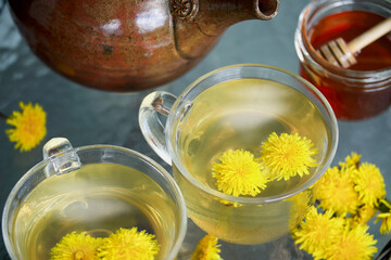 Overhead view of dandelion tea with fresh flowers and teapot