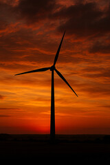 Fototapeta premium Silhouette of Wind Turbine at Sunset with Dramatic Sky 