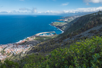 Aerial view of old town Garachico from Mirador de Garachico view point. Colorful houses and harbor. Ocean shore with lava rock pools. Popular tourist destination, Tenerife Canary Islands.