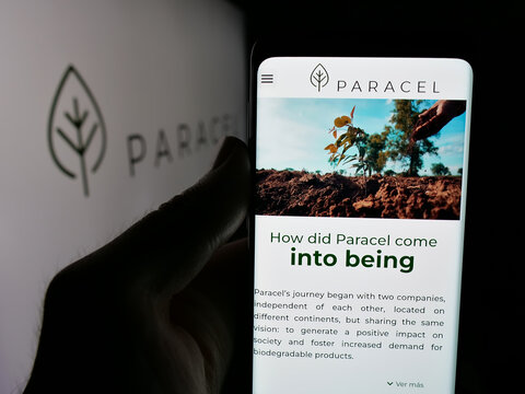Stuttgart, Germany - 05-04-2025: Person holding cellphone with web page of pulp and paper company Paracel S.A. on screen in front of logo. Focus on center of phone display.