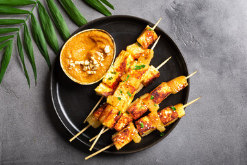 Grilled tofu satay skewers and peanut spicy sauce
