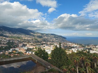 Naklejka premium madeira island, blue, landscape, sky, cityescape, pebbles, rock, mountain, cliff, clouds, day, sesaon, madeira, portugal, europe, travel, tourism, nature