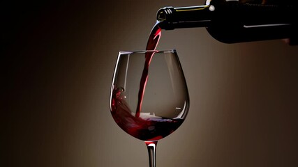 Wine bottle pouring rich red wine into elegant glass, closeup on luxury drink serving, fine dining experience, celebration toast, alcohol beverage concept, hospitality marketing, restaurant and bar co